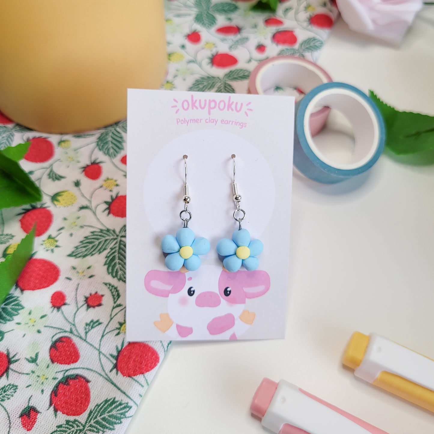 cute handmade blue daisy earrings made out of polymer clay