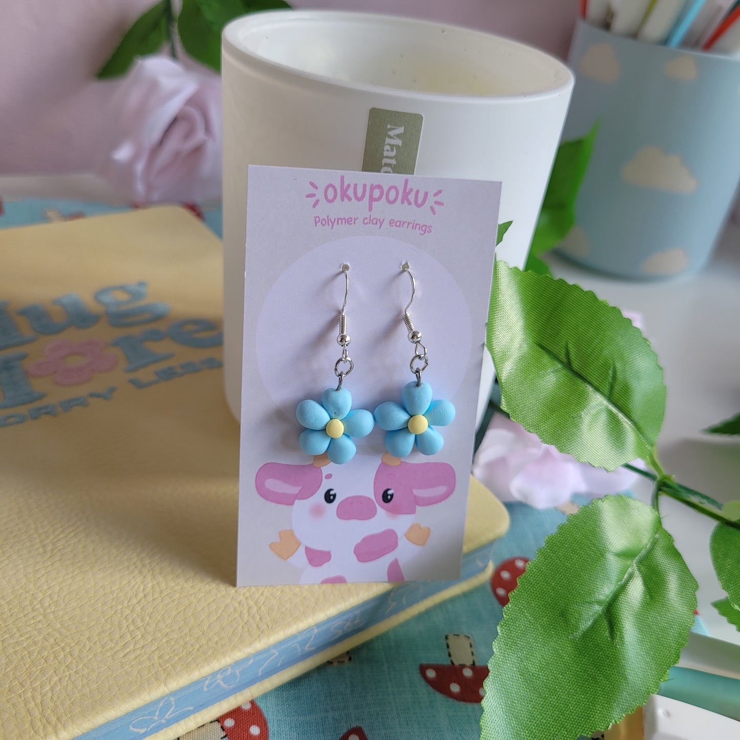 cute handmade blue daisy earrings made out of polymer clay