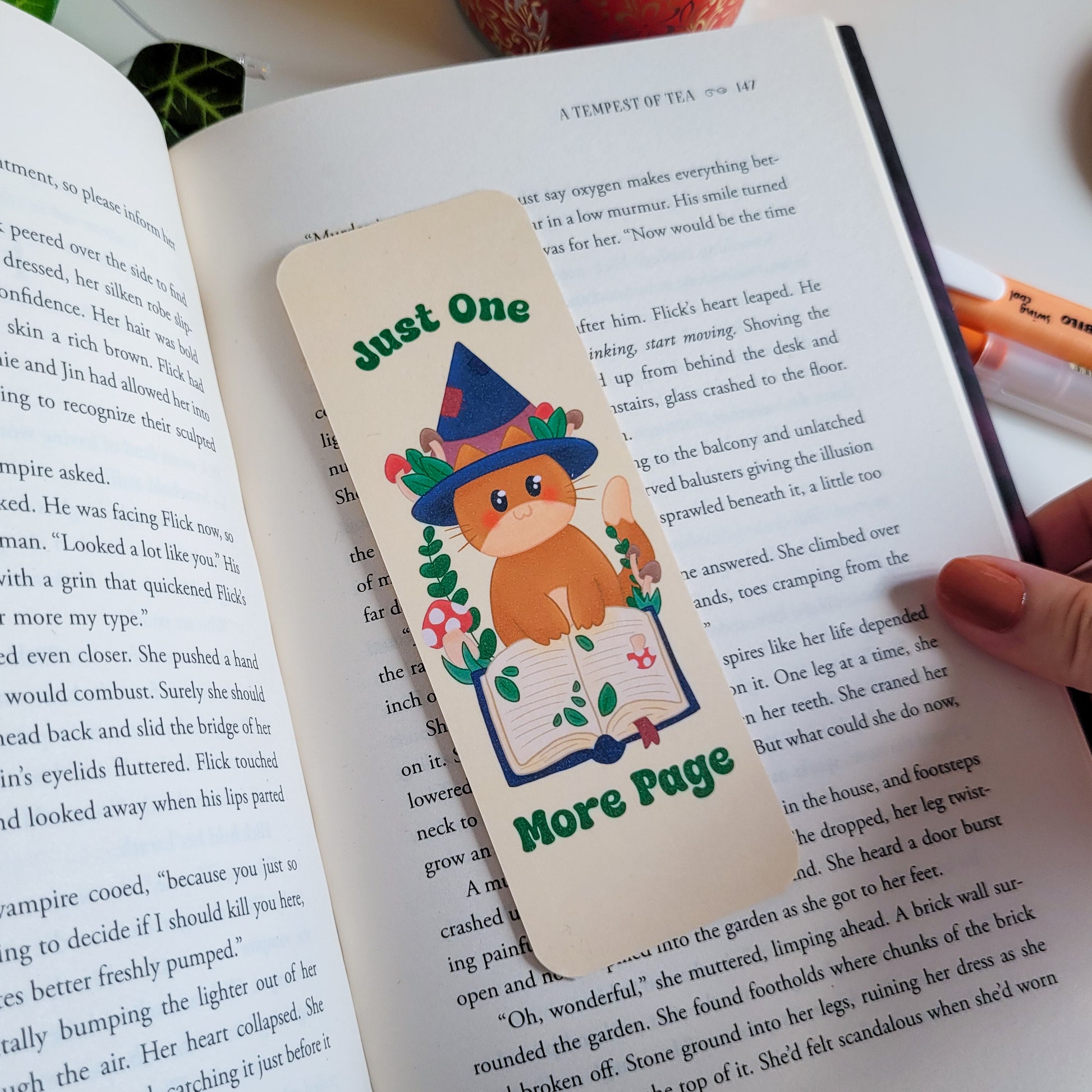 Cute cat witch bookmark featuring the text "Just one more page"