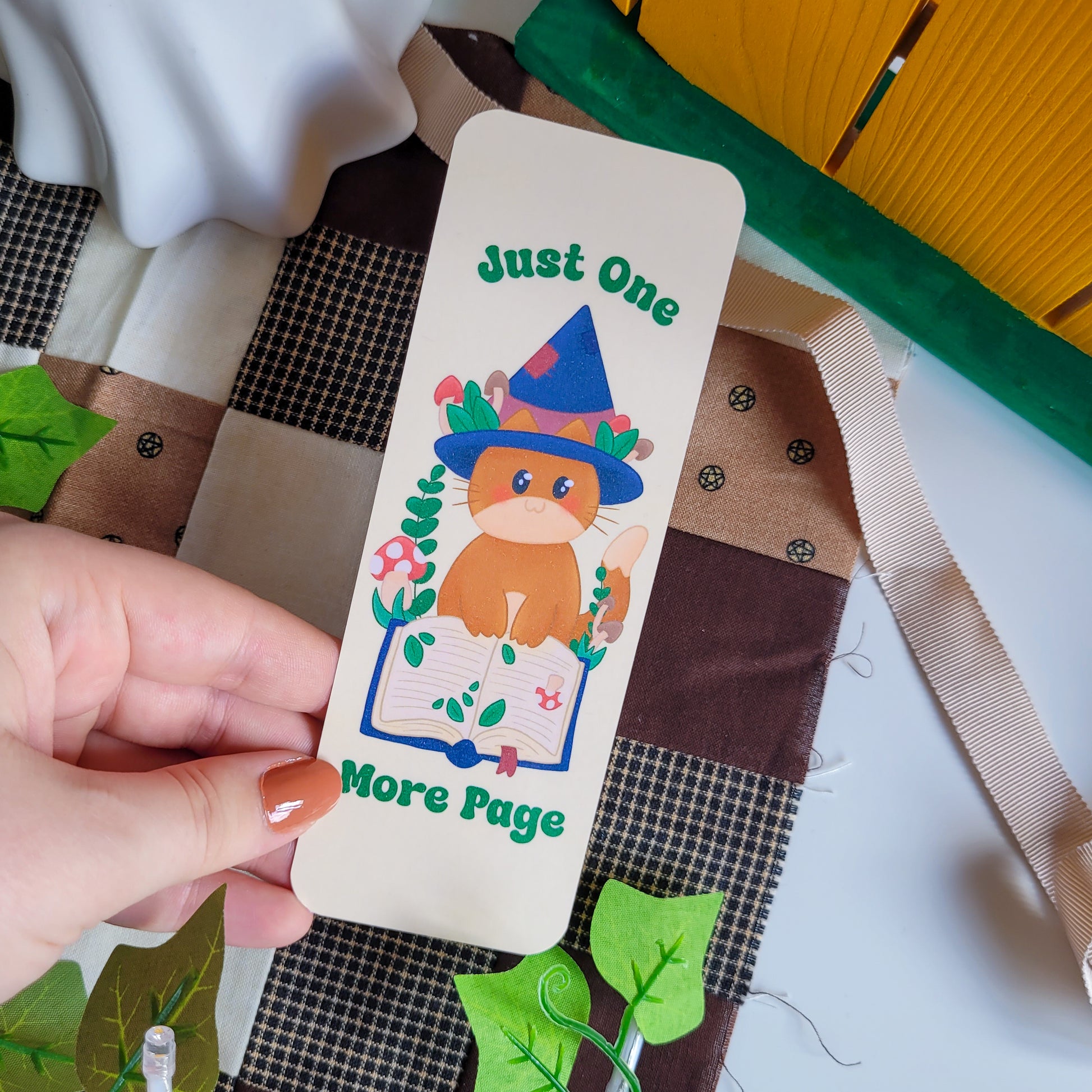 Cute cat witch bookmark featuring the text "Just one more page"