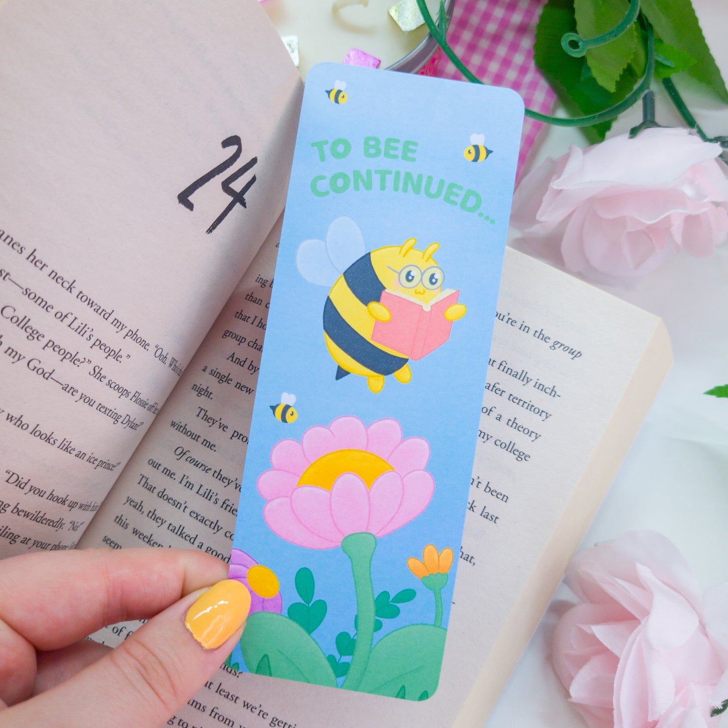 to bee continued bookmark featuring a bee reading among flowers