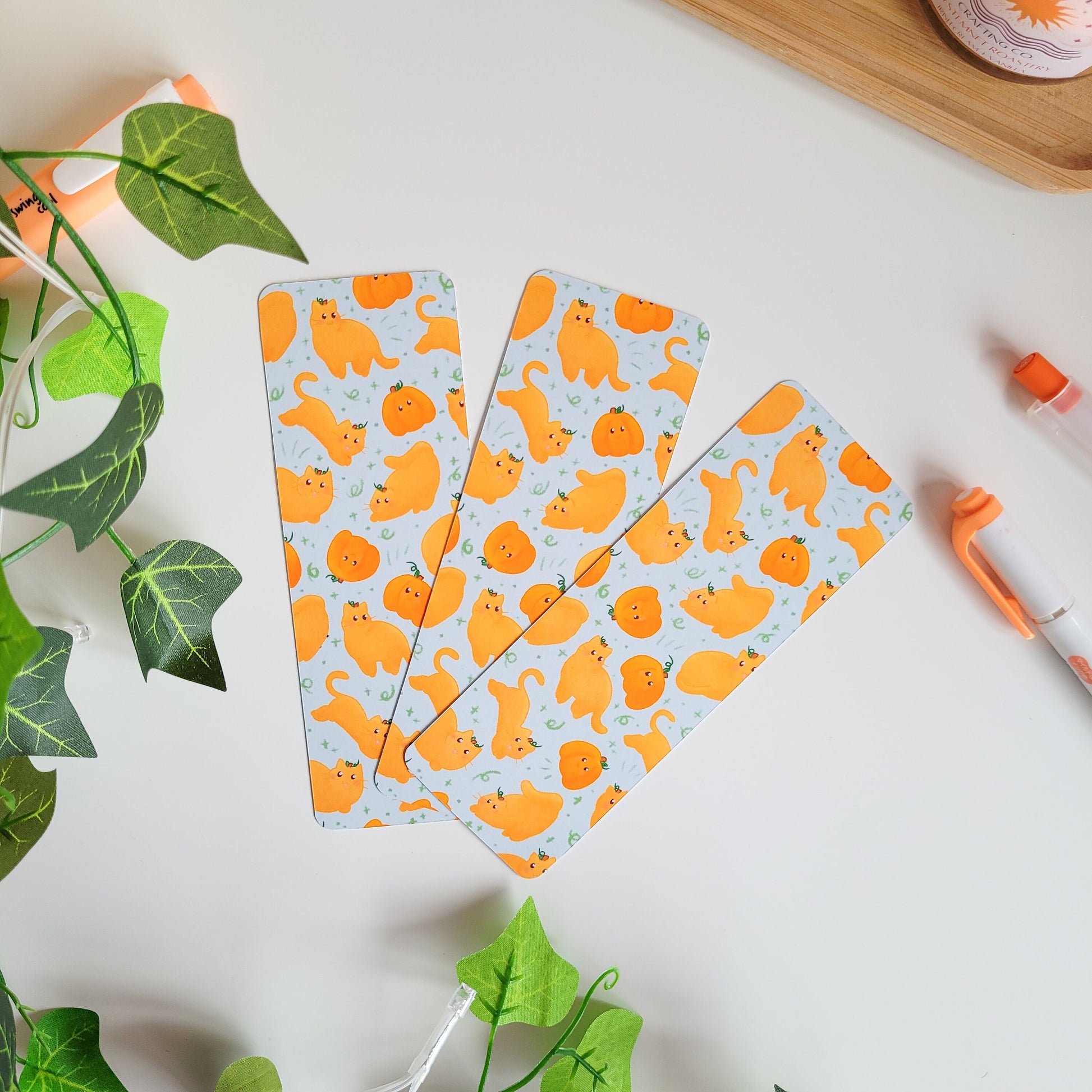 Cute Autumn bookmark featuring cats dressed as pumpkins