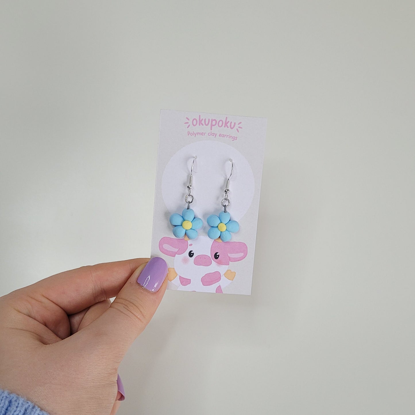 cute handmade blue daisy earrings made out of polymer clay
