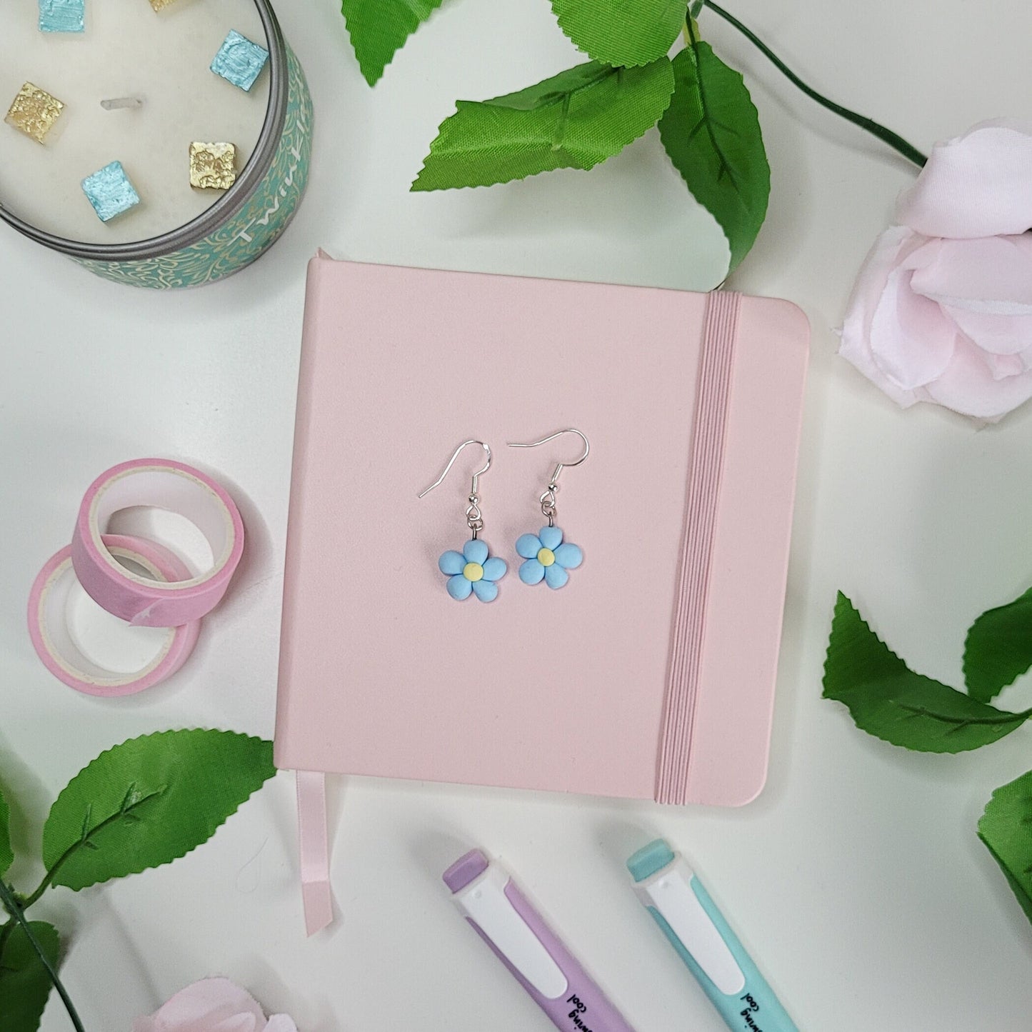 cute handmade blue daisy earrings made out of polymer clay